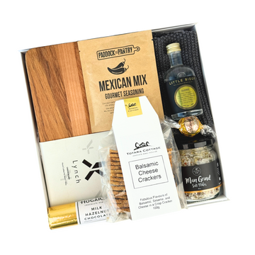 Gift set with Mexican Mix seasoning, chocolate bar, crackers, and other items in a box.